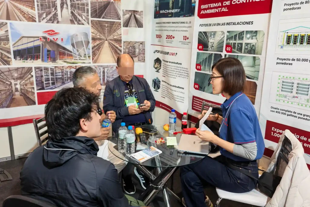poultry farmers discussing automatic poultry farming equipment with LIVI team at SIAVS 2026